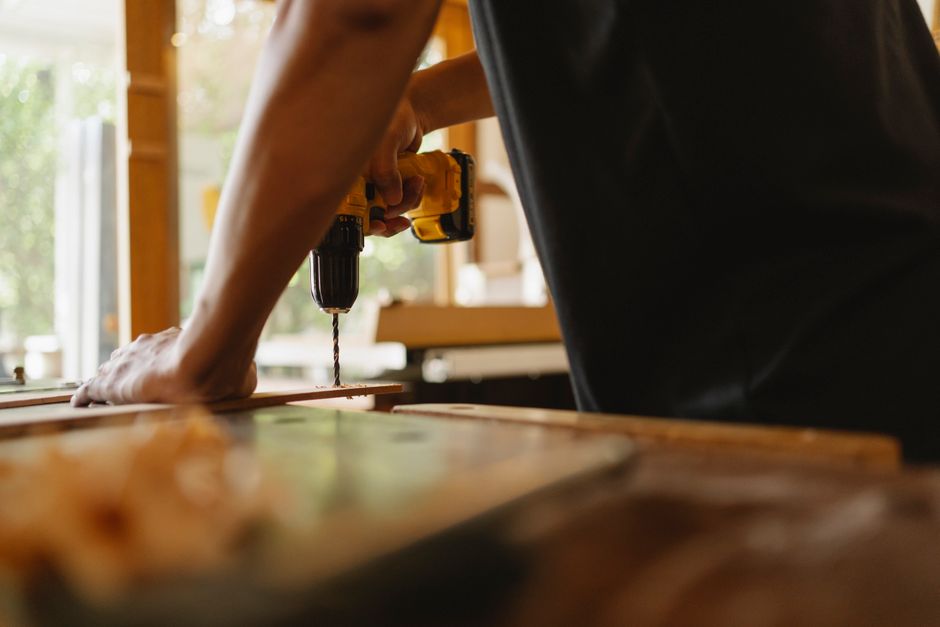 Master carpenter carefully measuring and installing a wooden door
